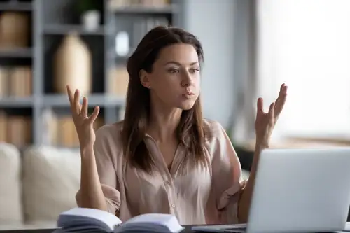 Frustrated woman working on a laptop